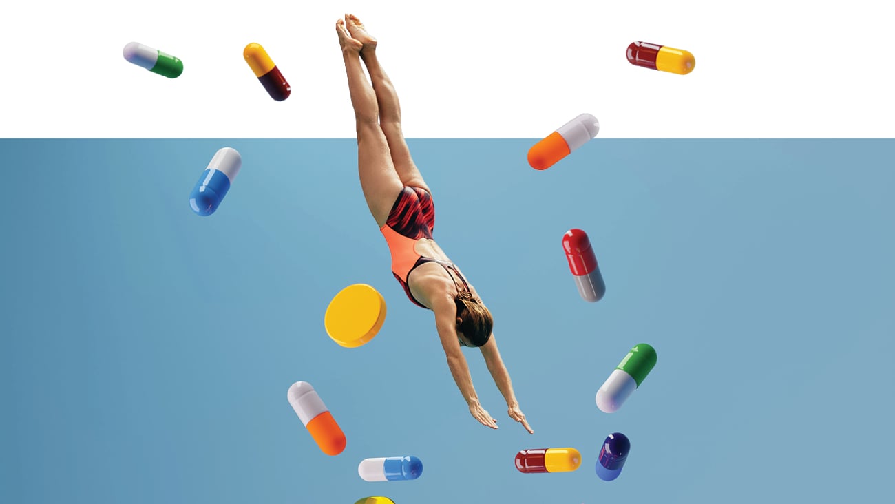 Cartoon of a woman diving into water surrounded by large pills