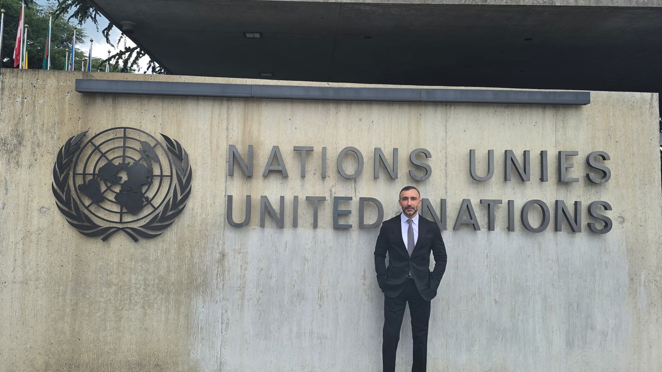 Sherif Guorgui standing in front of the United Nations