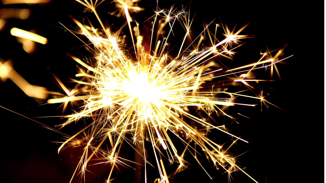 A yellow sparkler against a black background