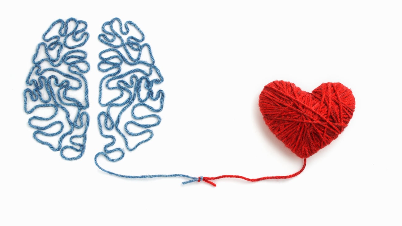 A brain and a heart connected by a red string
