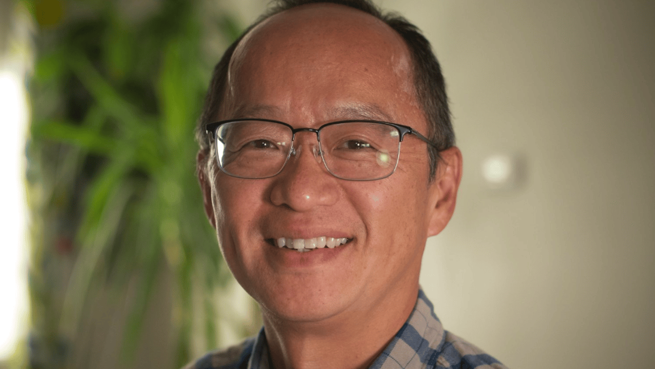Middle aged Asian man smiling for a photo