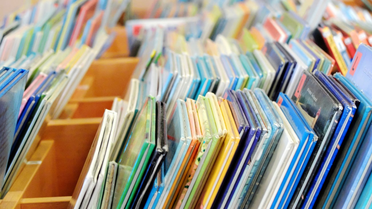 Children's books in a bin at the library