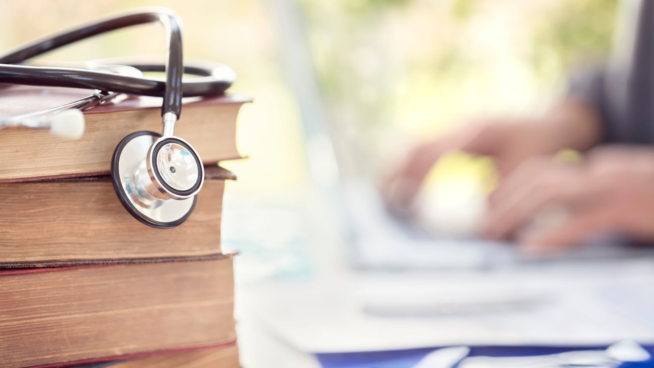 Books with a stethoscope draped over them