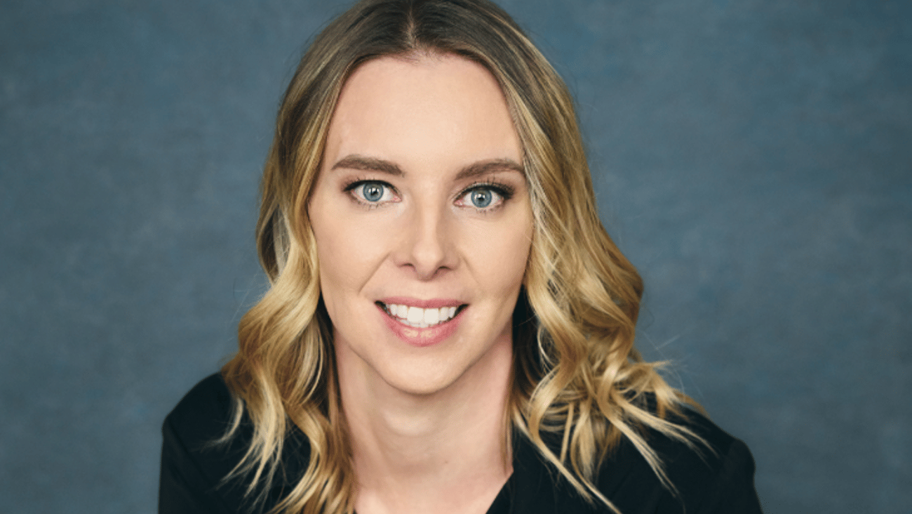 A blonde woman smiling for a photo
