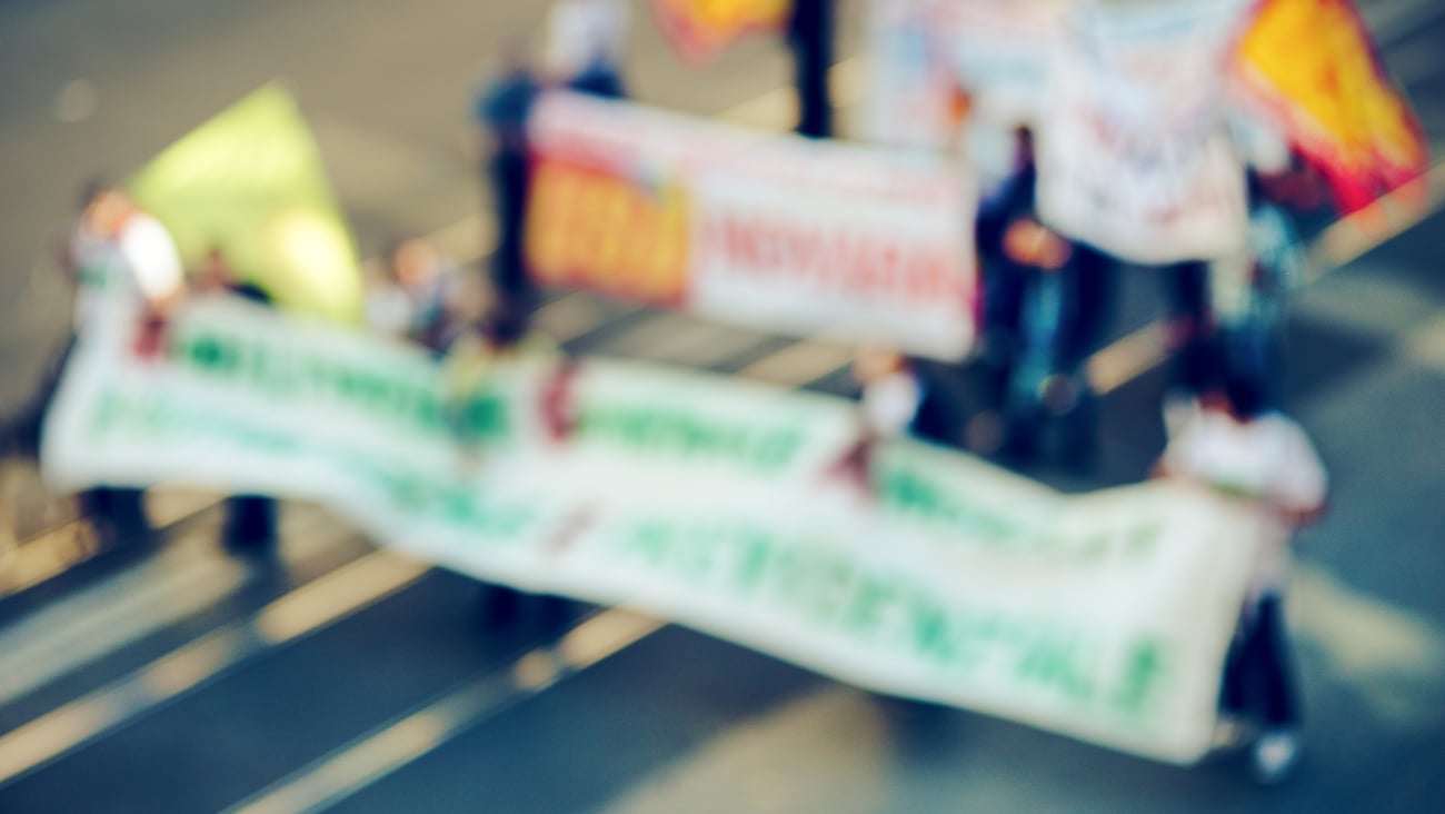 Blurry photo of workers picketing because they are on strike