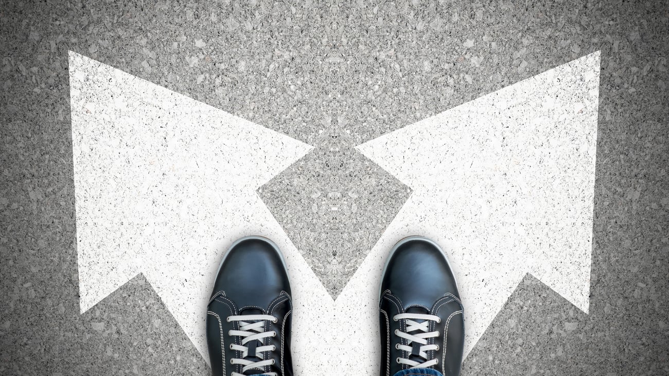 2 feet standing on arrows that diverge in two directions