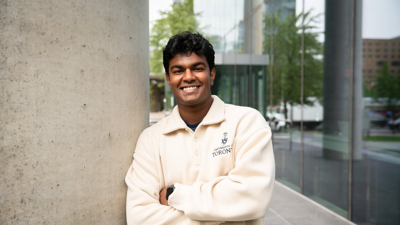 PharmD student Dulain Abeyratne standing against a pillar