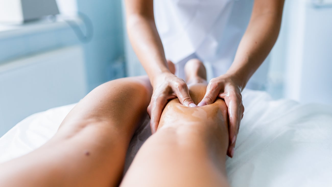 Woman getting a sports medicine massage on her legs