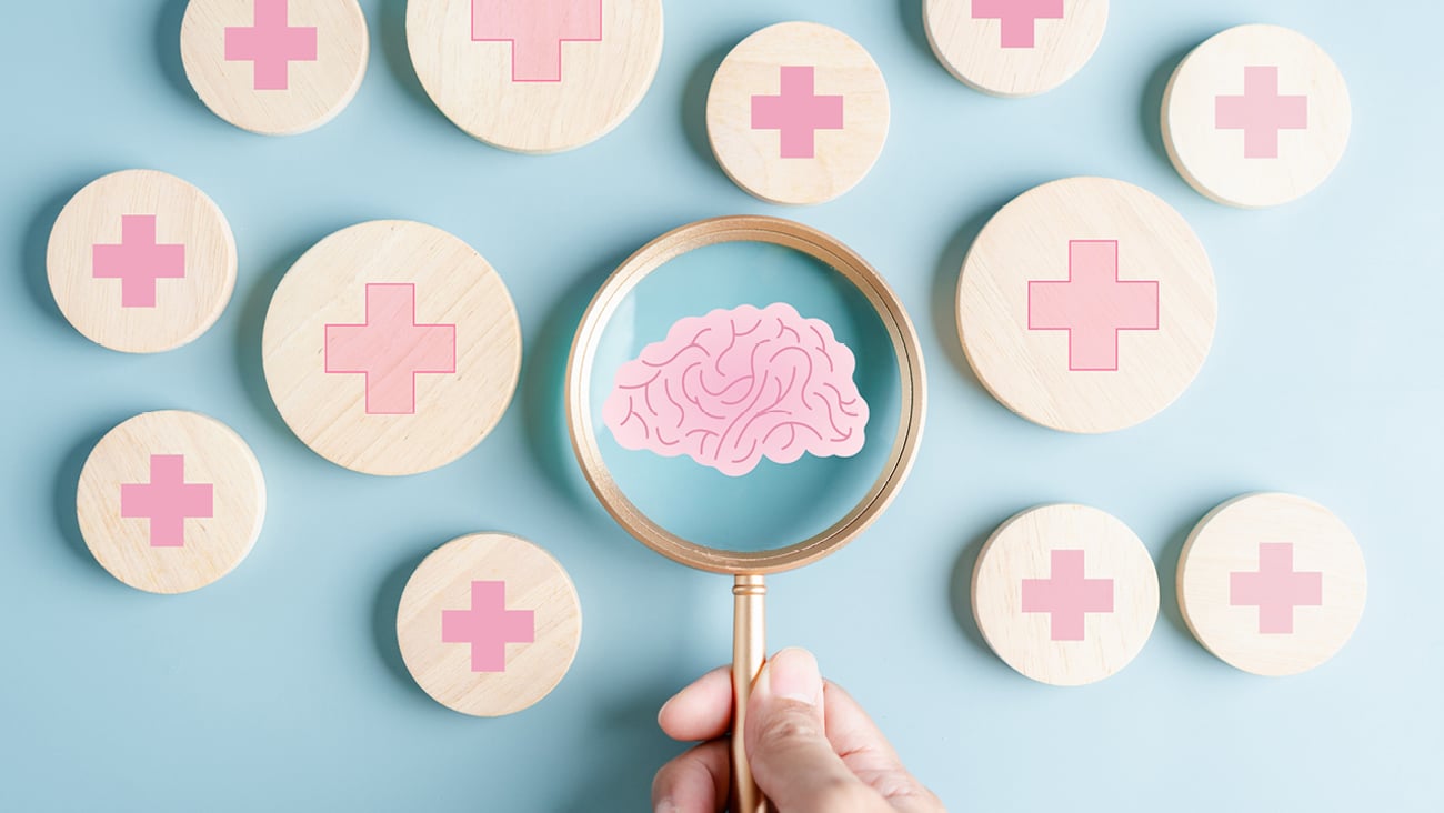 A magnifying glass roving over options and zeroing in on a picture of a brain