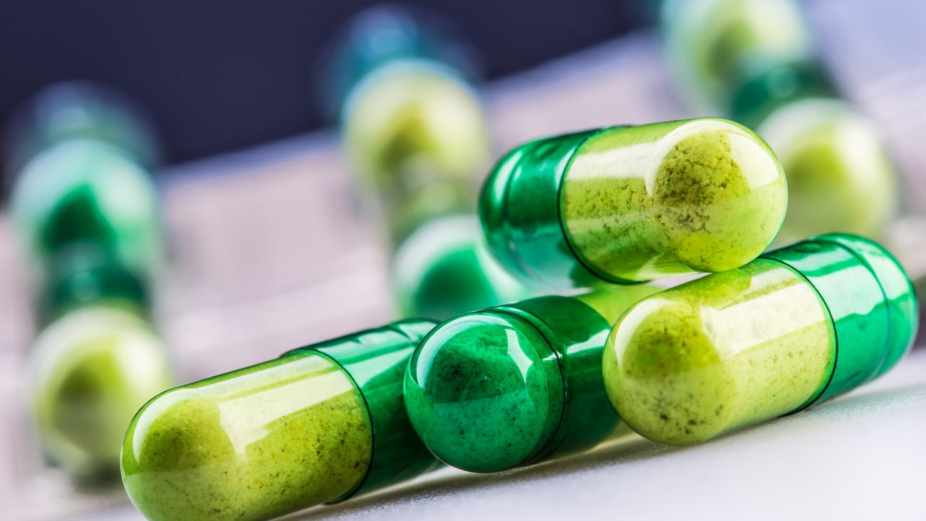Green pile of capsule pills
