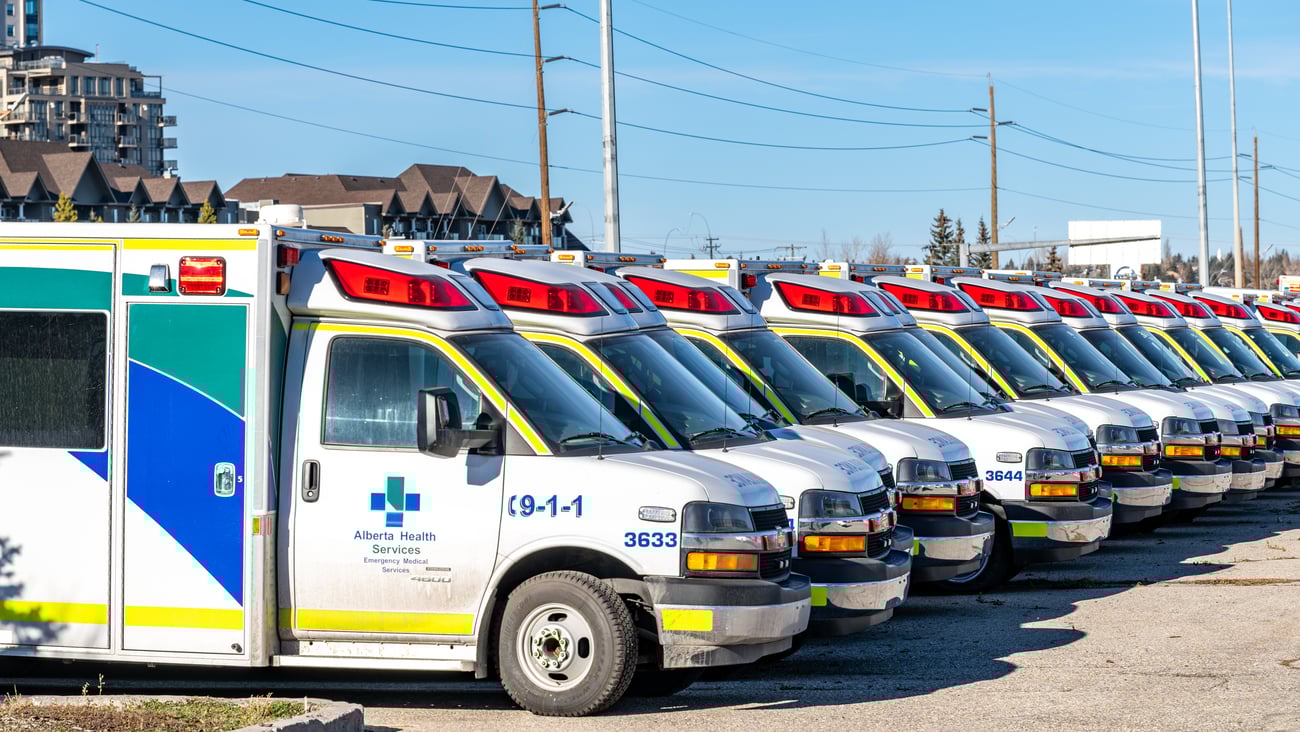 EMS ambulances parked in an Alberta Health Services parking lot in Calgary.