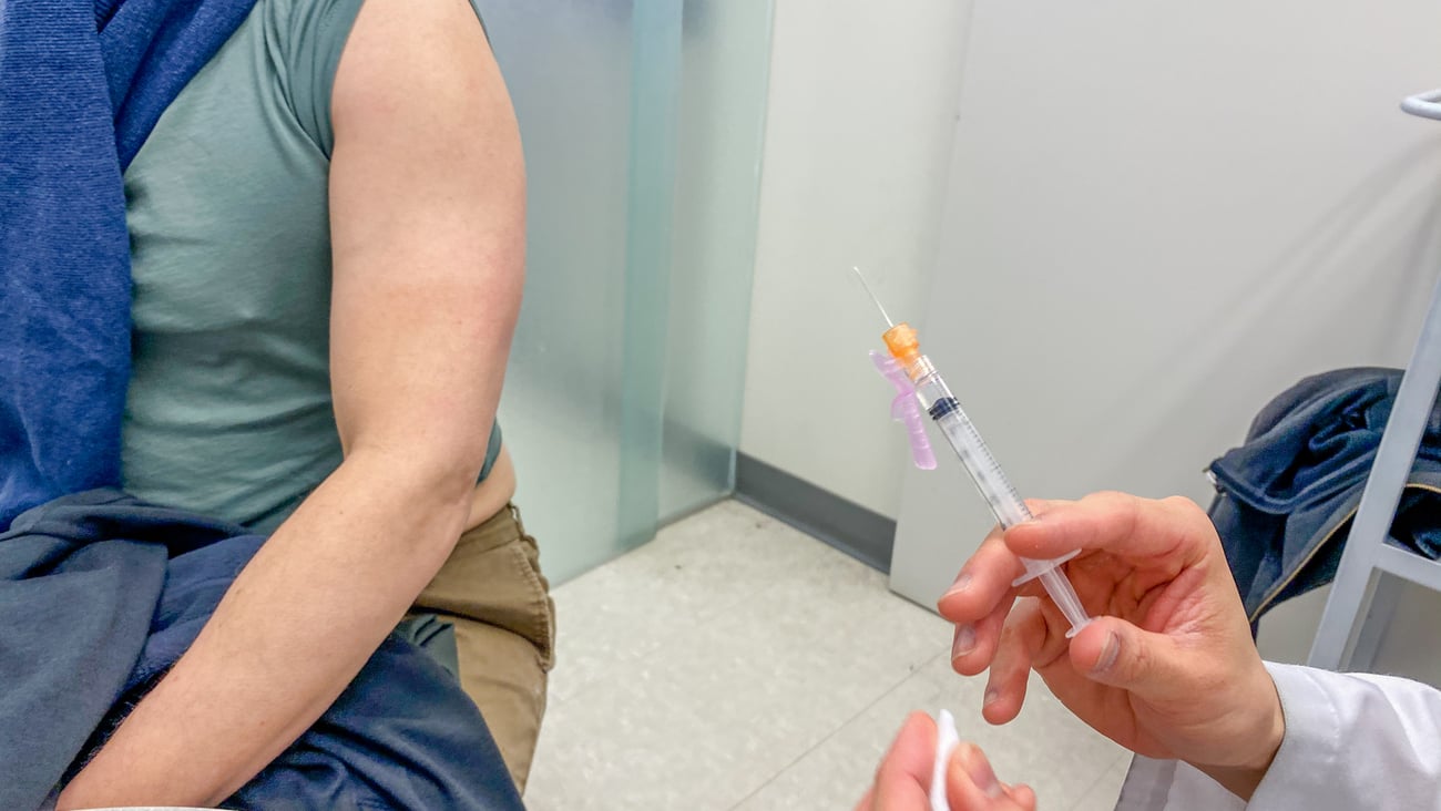 A person receives a COVID-19 vaccine during the pandemic.