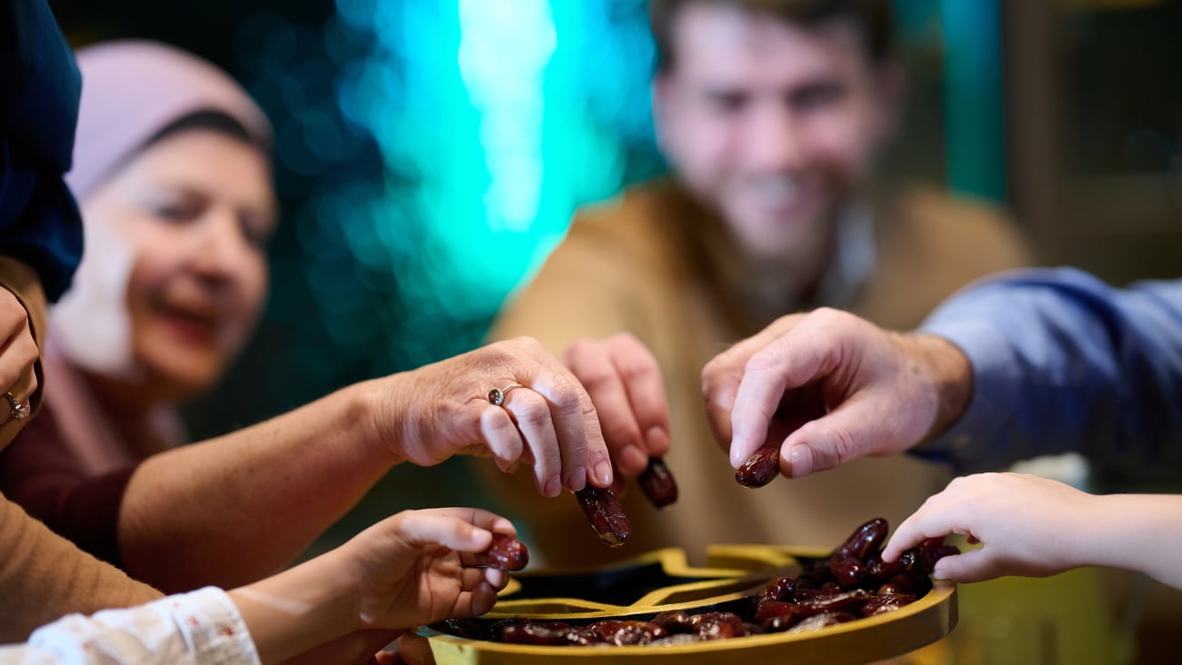 A Muslim family sharing dates to break the Ramadan fast