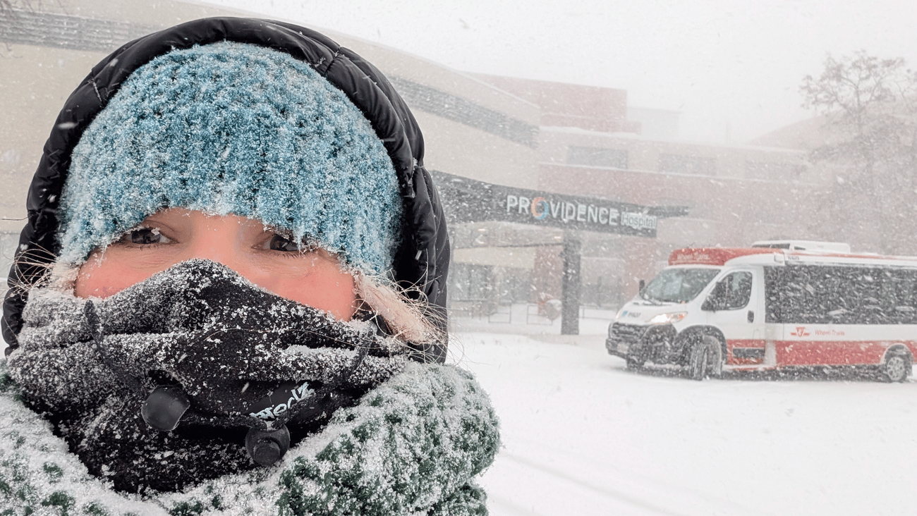 Julee Joseph in the snow in front of a pharmacy