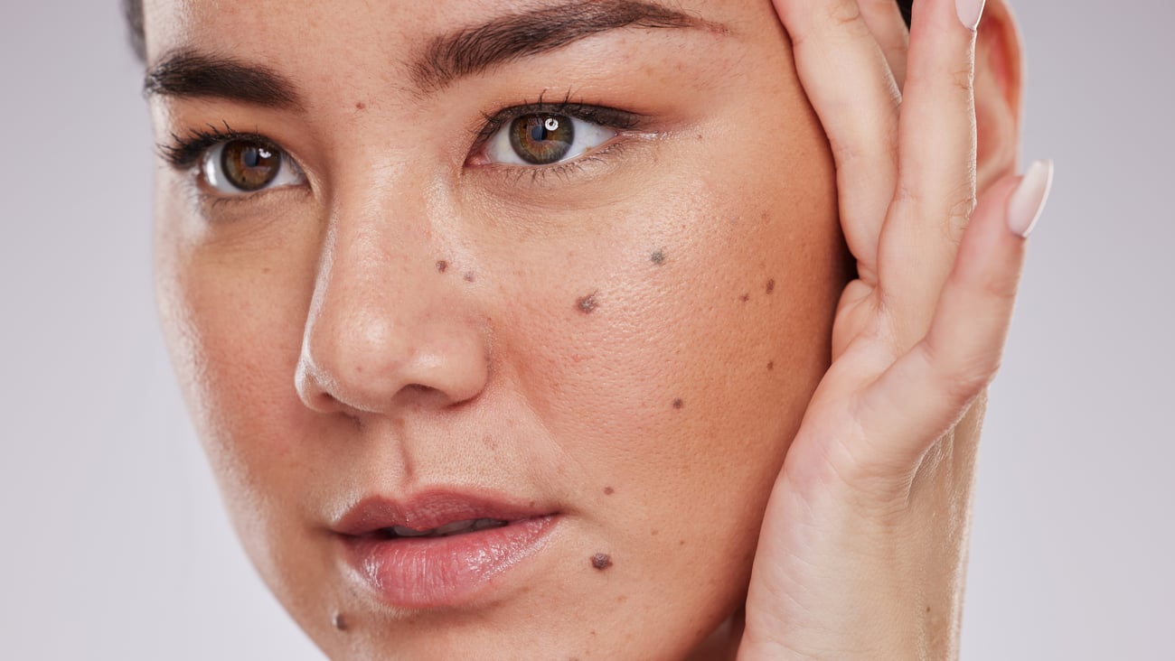 Young woman admiring herself in the mirror 