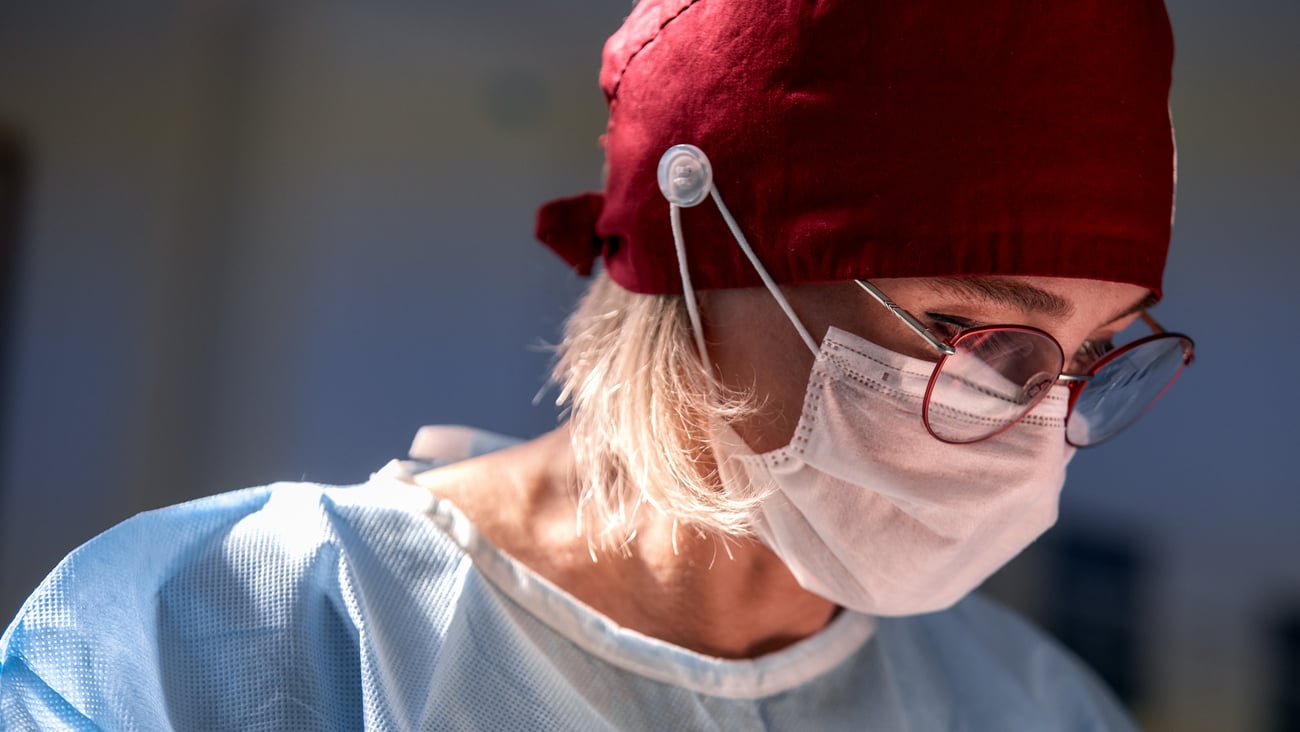 Surgeon with a red head covering