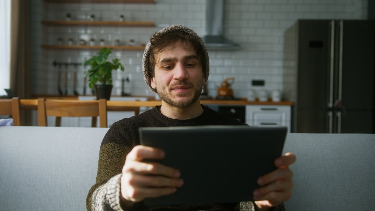 Young man watching a video on a tablet