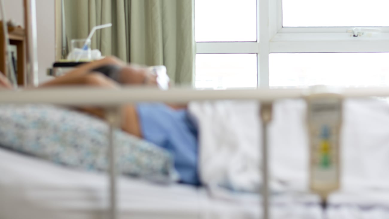 Blurry frame of a woman laying in a hospital bed