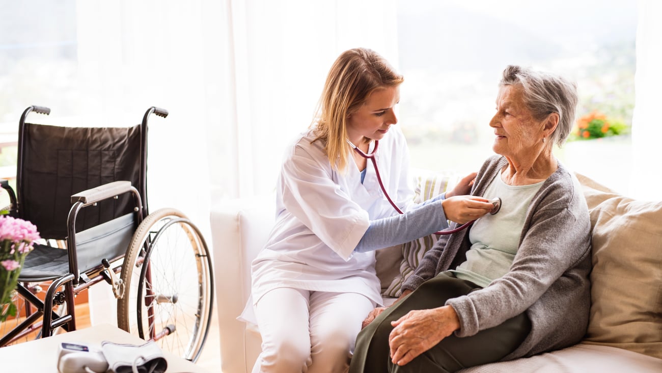A doctor makes a home visit to an elderly patient.