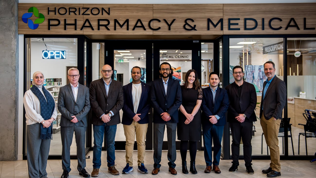 Doctors and pharmacists standing in front of the Horizon Pharmacy and Medical clinic in Edmonton