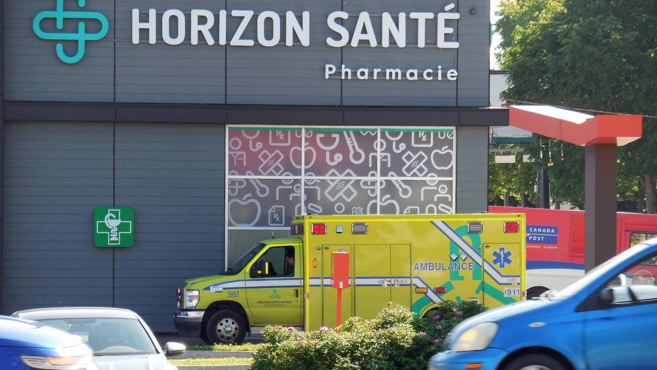 An ambulance sits outside a Quebec pharmacy