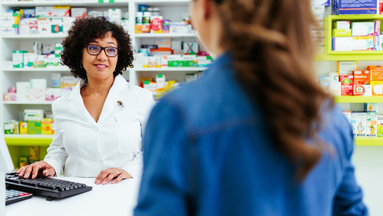 Pharmacist and the back of a patient