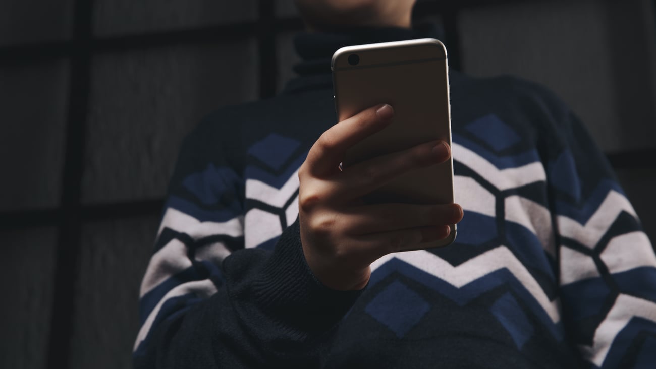 Young teen boy looking at a smartphone
