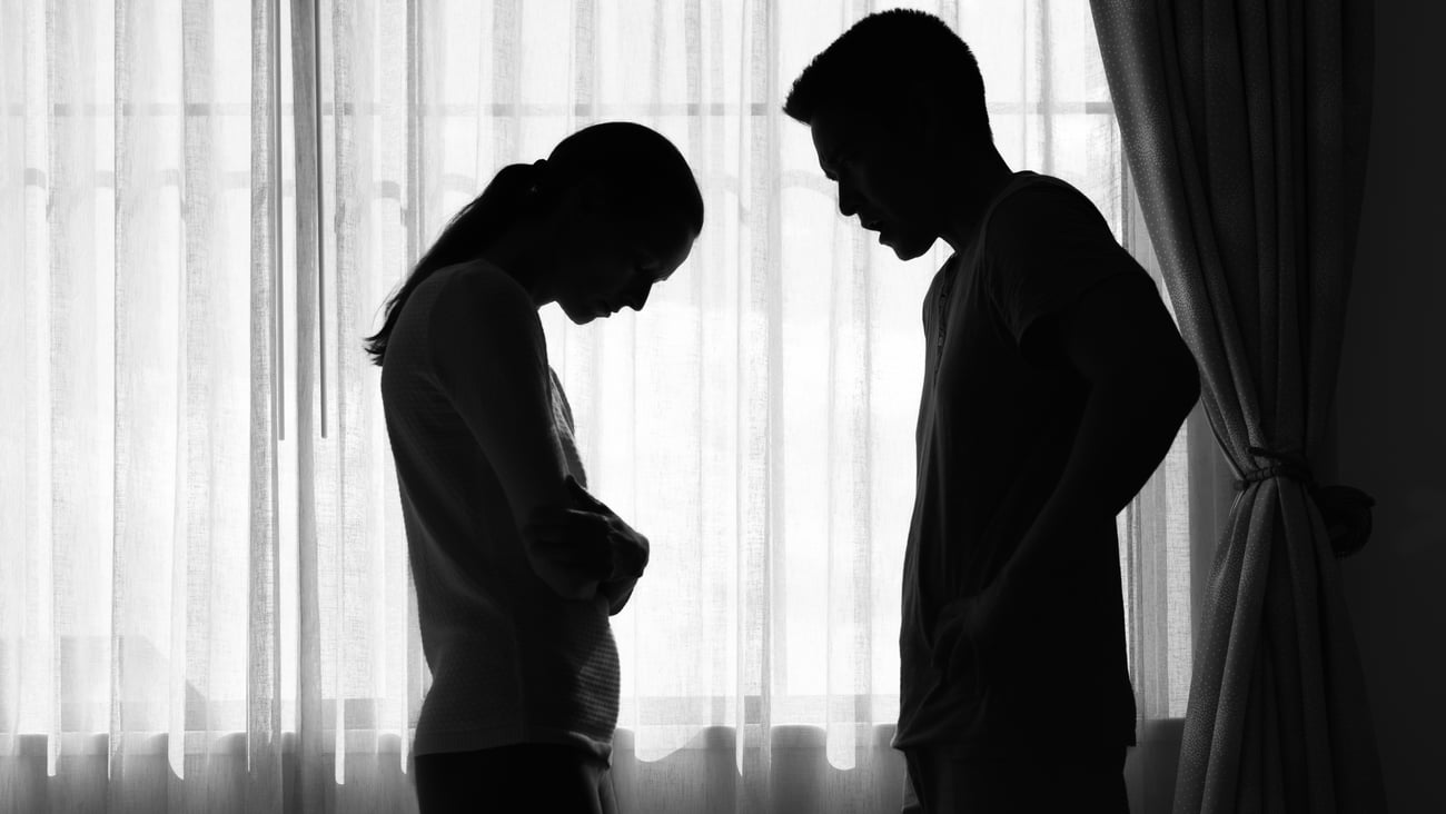 A silhouette of a couple arguing.