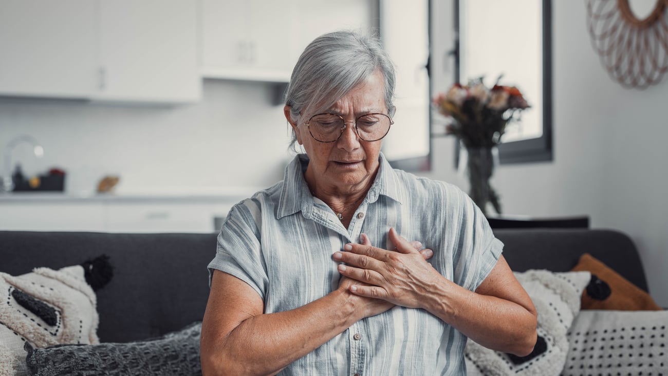 Older woman holding her chest in alarm