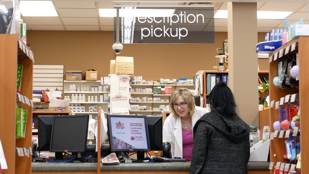 A person picks up her prescription at a pharmacy in Port Coquitlam, B.C.