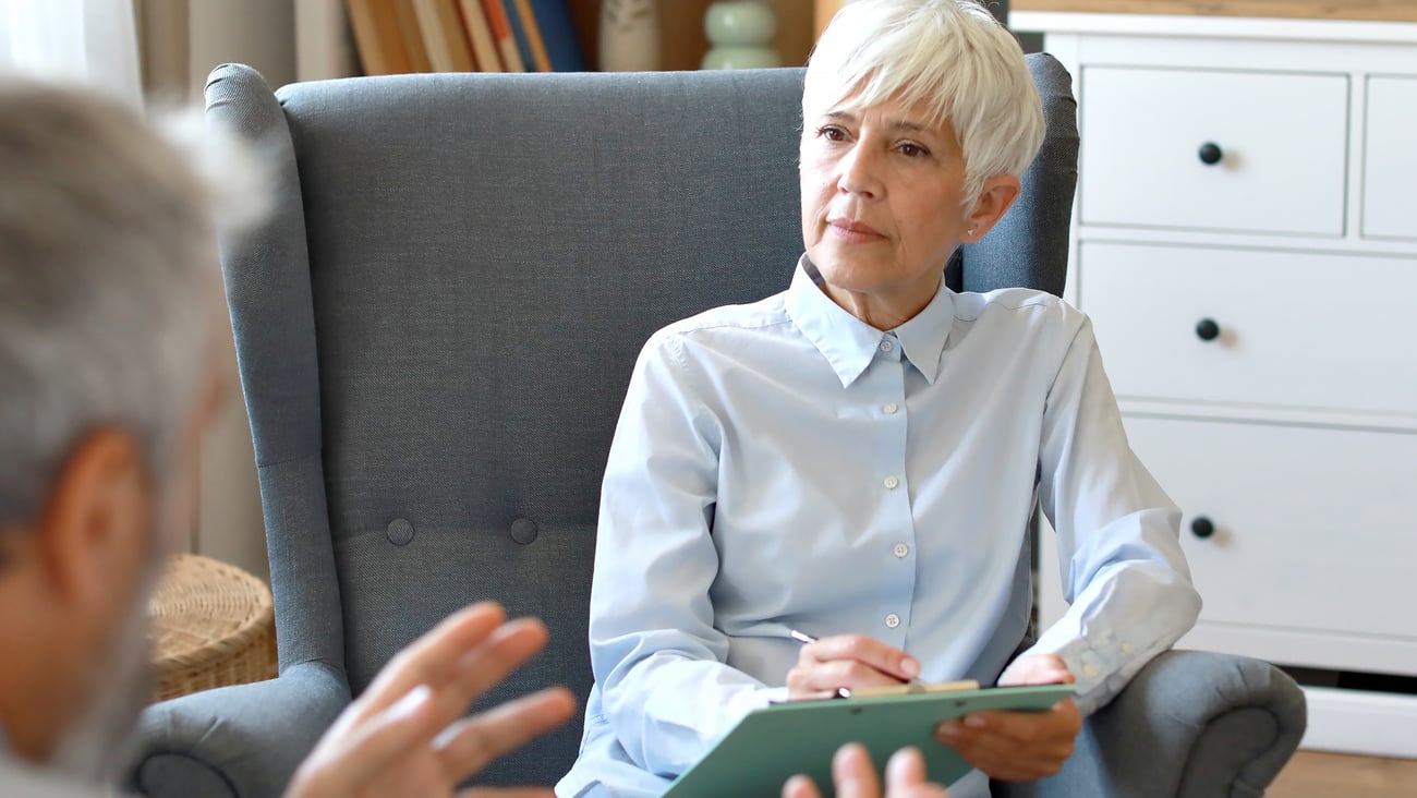 Older woman psychiatrist chatting with a patient