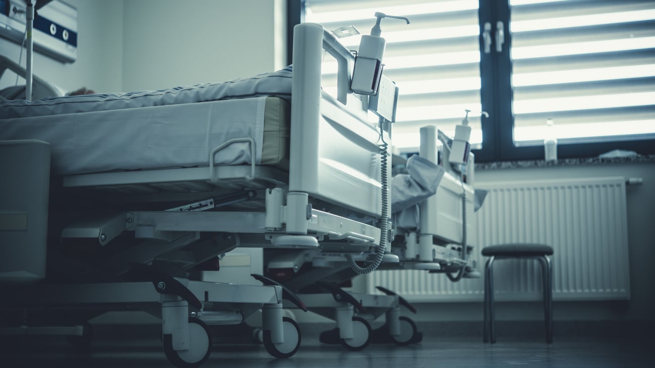 Hospital beds in a hospital room.