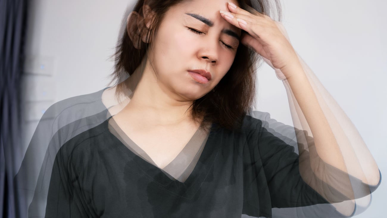 Woman holding her head feeling dizzy