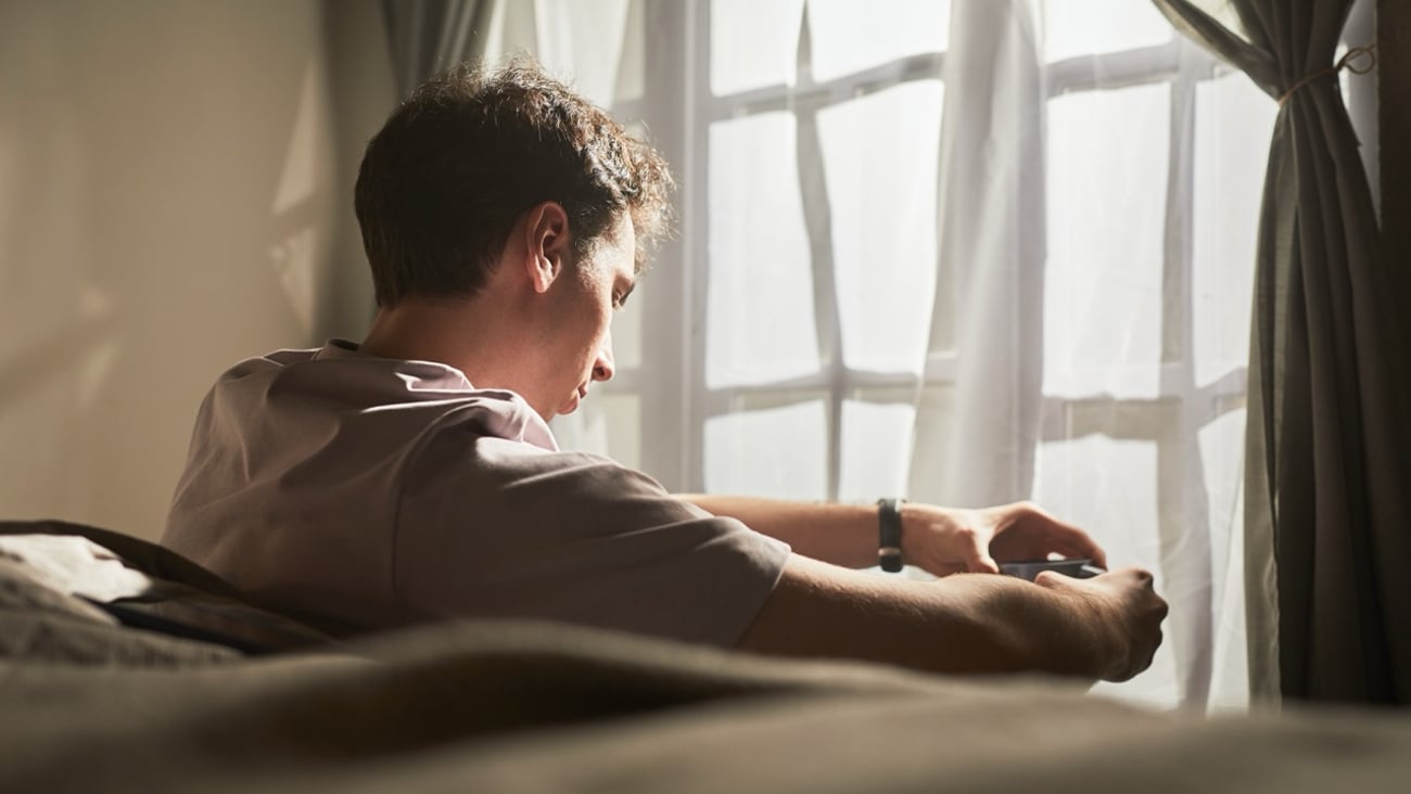A young man looks out the window.
