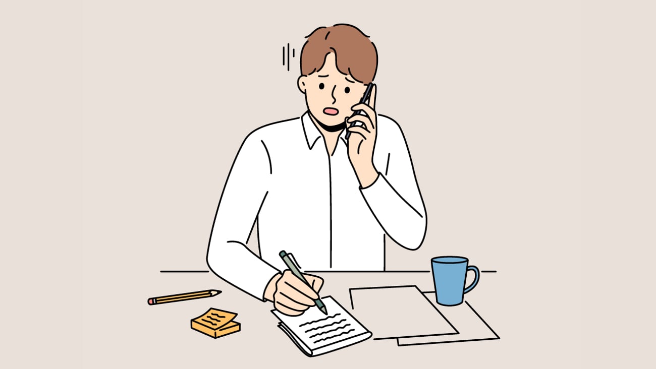 A cartoon of a nervous, busy man working while on the phone