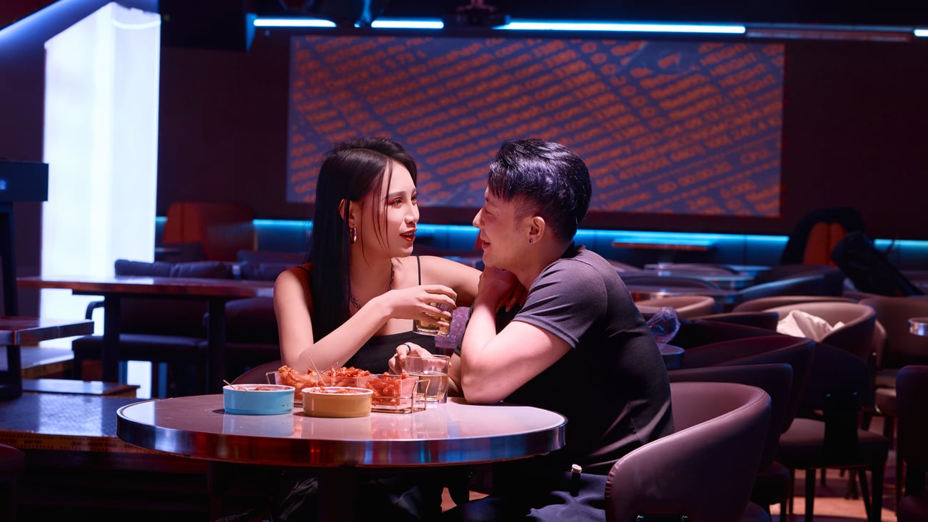 A young couple sitting together at a bar