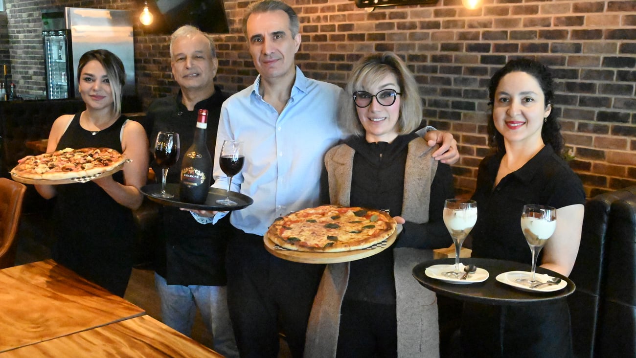 Shawn Hatami (middle left), Shirin Hatami (middle right) and the rest of the staff from Roma Italian Restaurant. (Abby Luciano / North Shore News)