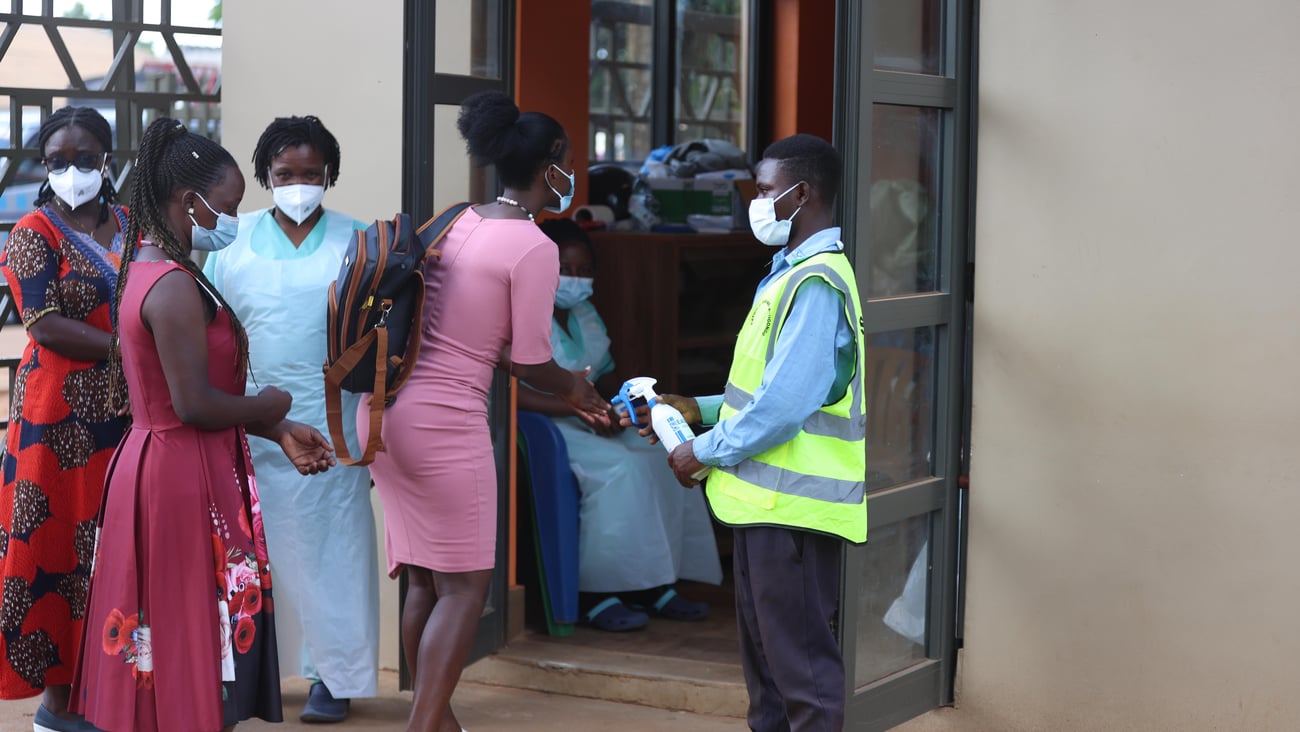 A lady sanitizes her hands before entering church as catholics attend holy mass at Uganda Martyrs Catholic Basilica Namugongo on June 3, 2026 in Kampala Uganda.