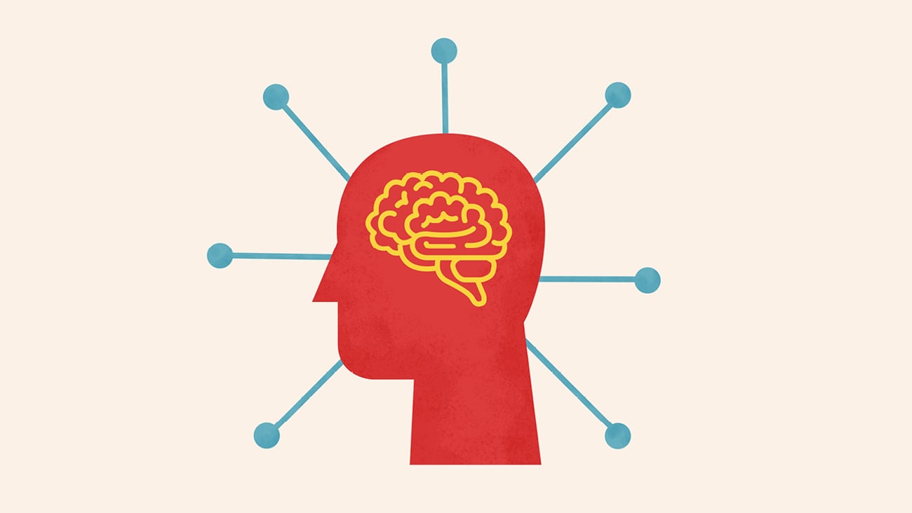 A cartoon of a human head in profile with a yellow cartoon brain inside