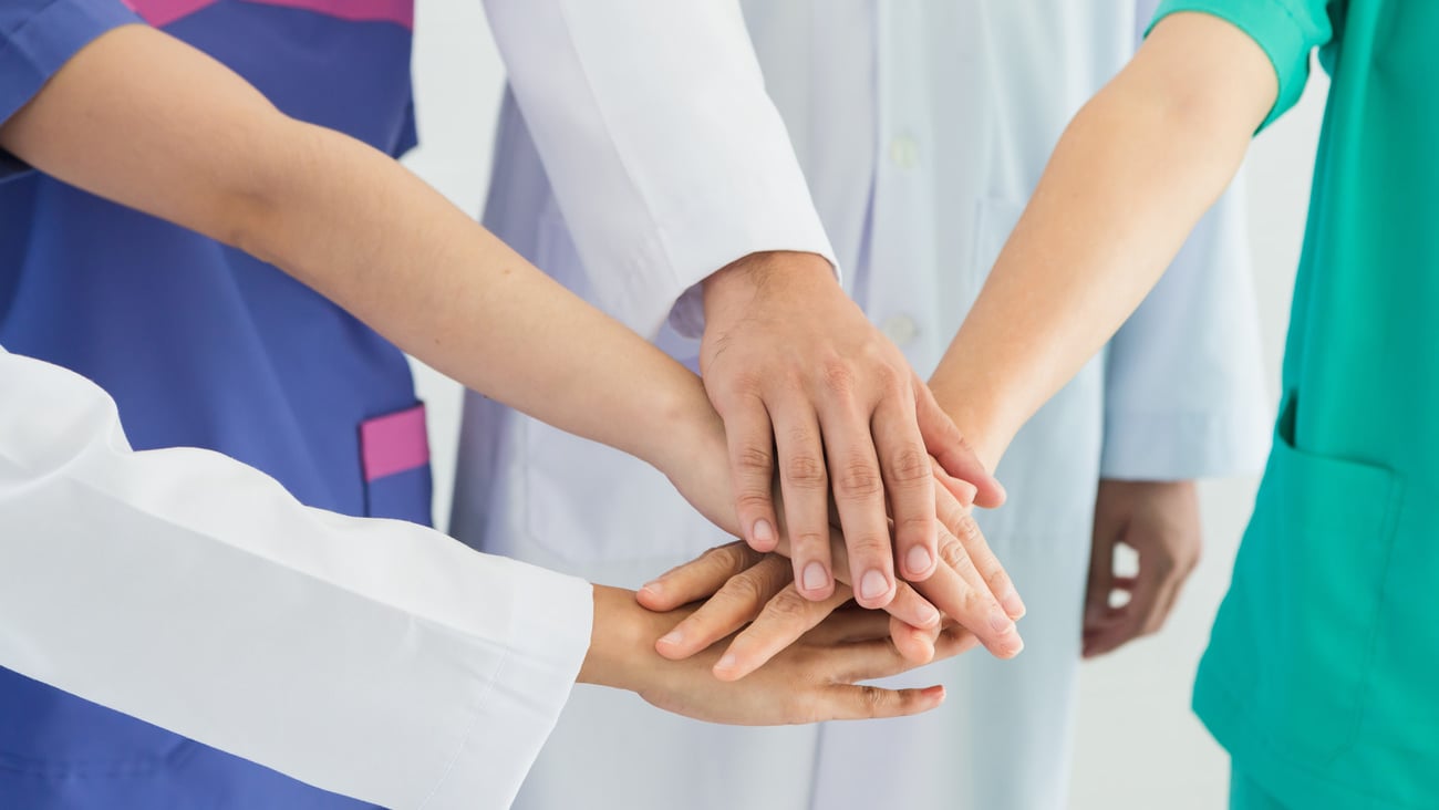 Medical people handshaking.Doctors and nurses in a medical team stacking hands cross.Concept of good teamwork in hospitals.; Shutterstock ID 1164347695