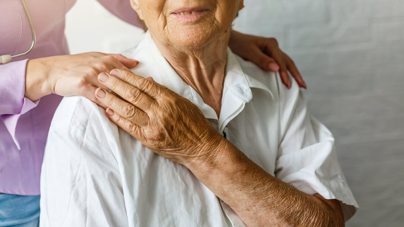 Elderly female hand holding hand of young caregiver at nursing home.Geriatric doctor or geriatrician concept. Doctor physician hand on happy elderly senior patient to comfort in hospital examination; Shutterstock ID 1444401491