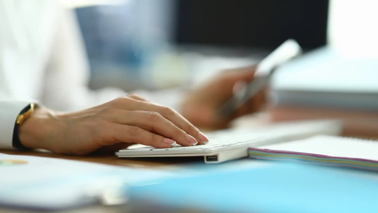 Nurse type text. Woman in white coat hold her hand on white keyboard. Doctor press button with her finger. On table are document, paper, form. Specialist serves population in workplace.; Shutterstock ID 1783657661