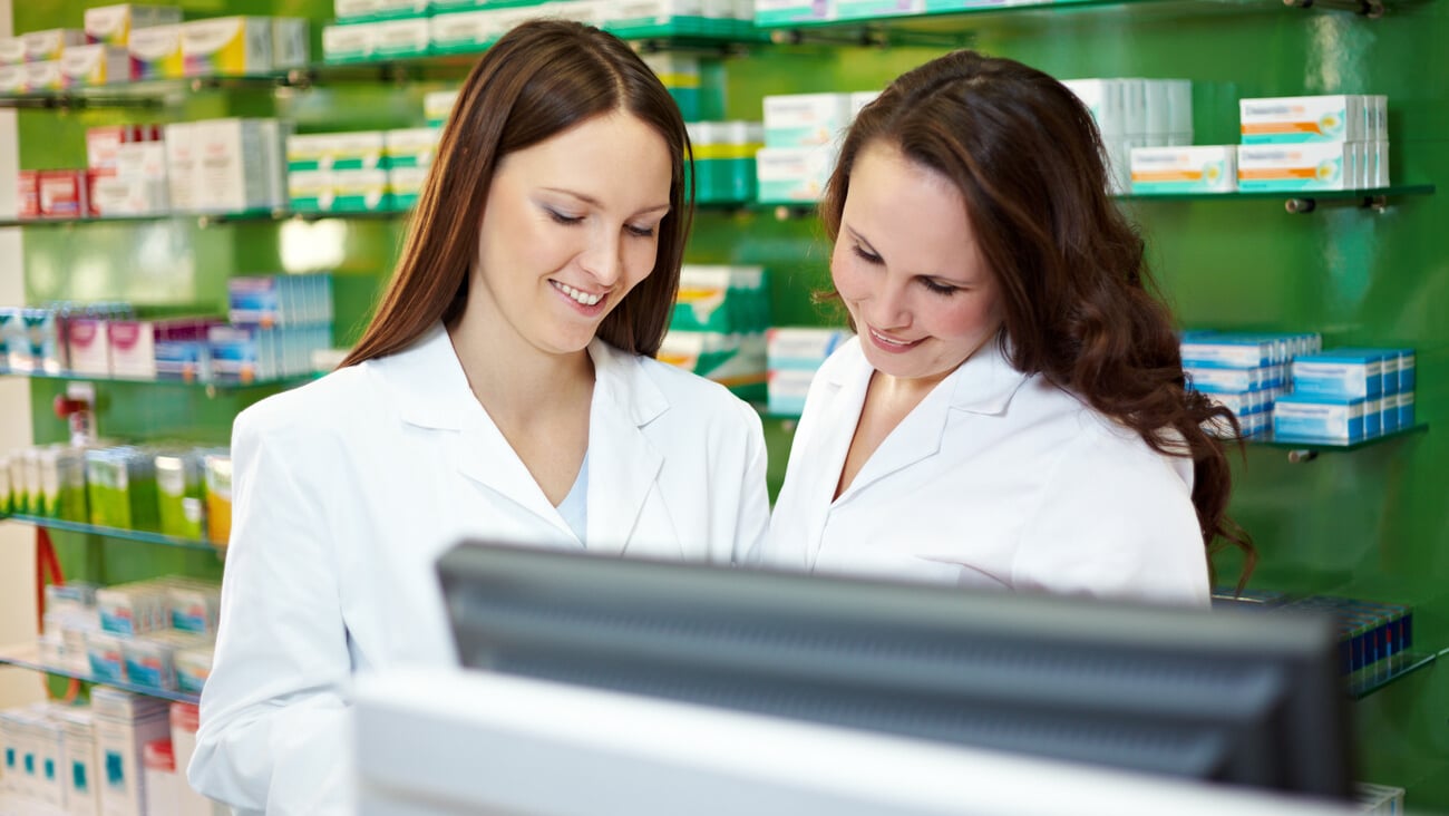 Pharmacist in pharmacy is training to be a PTA; Shutterstock ID 1830179318
