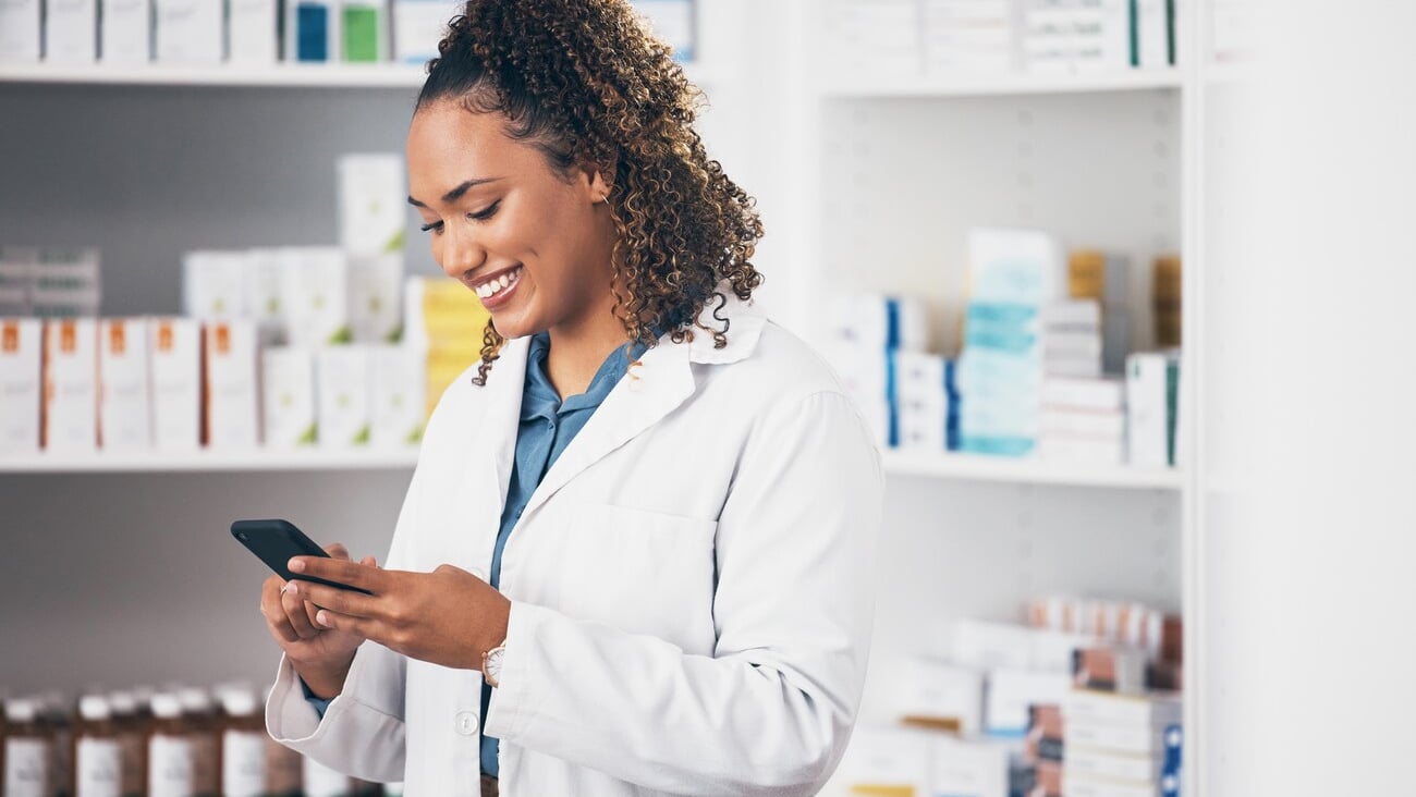 Pharmacist, phone or happy woman texting in pharmacy to contact, email communication or reading chat. Social media, or doctor on mobile app, typing or searching medical news on internet in workplace; Shutterstock ID 2288693529