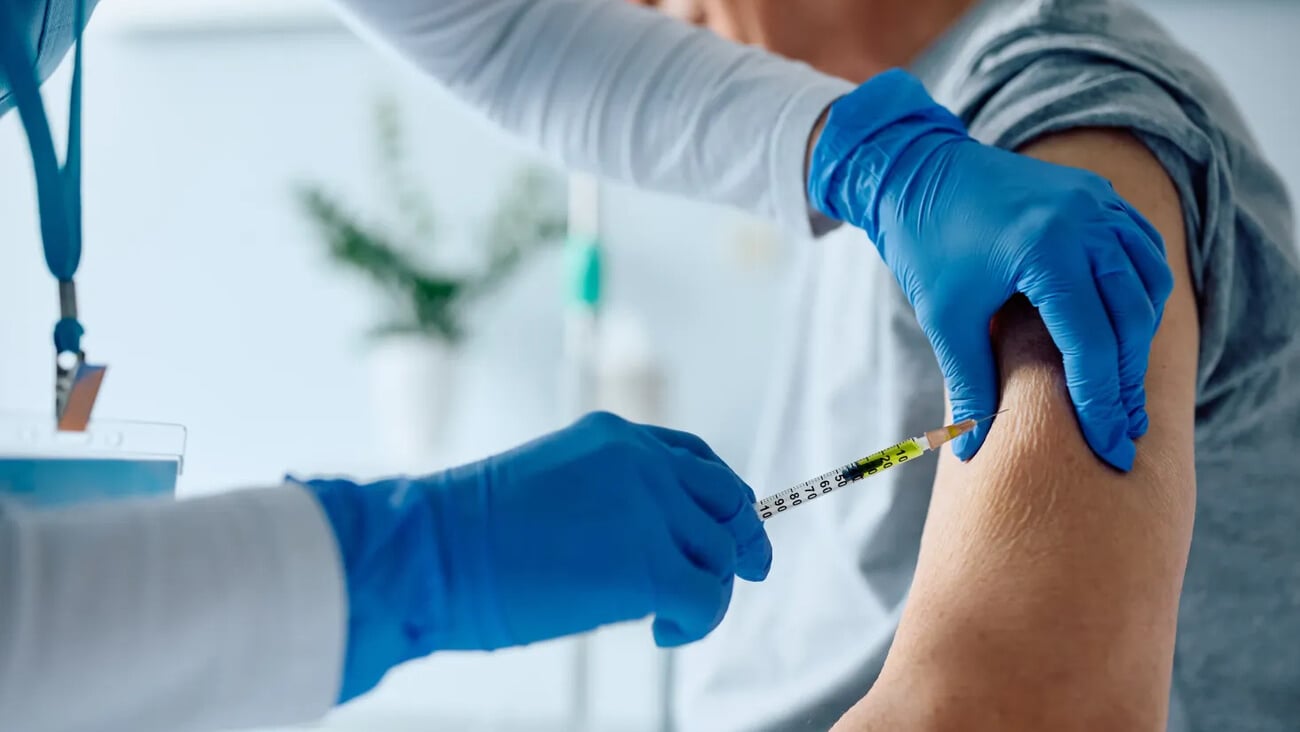 Close up of senior man receiving vaccine while recovering in the hospital.; Shutterstock ID 2314256187
