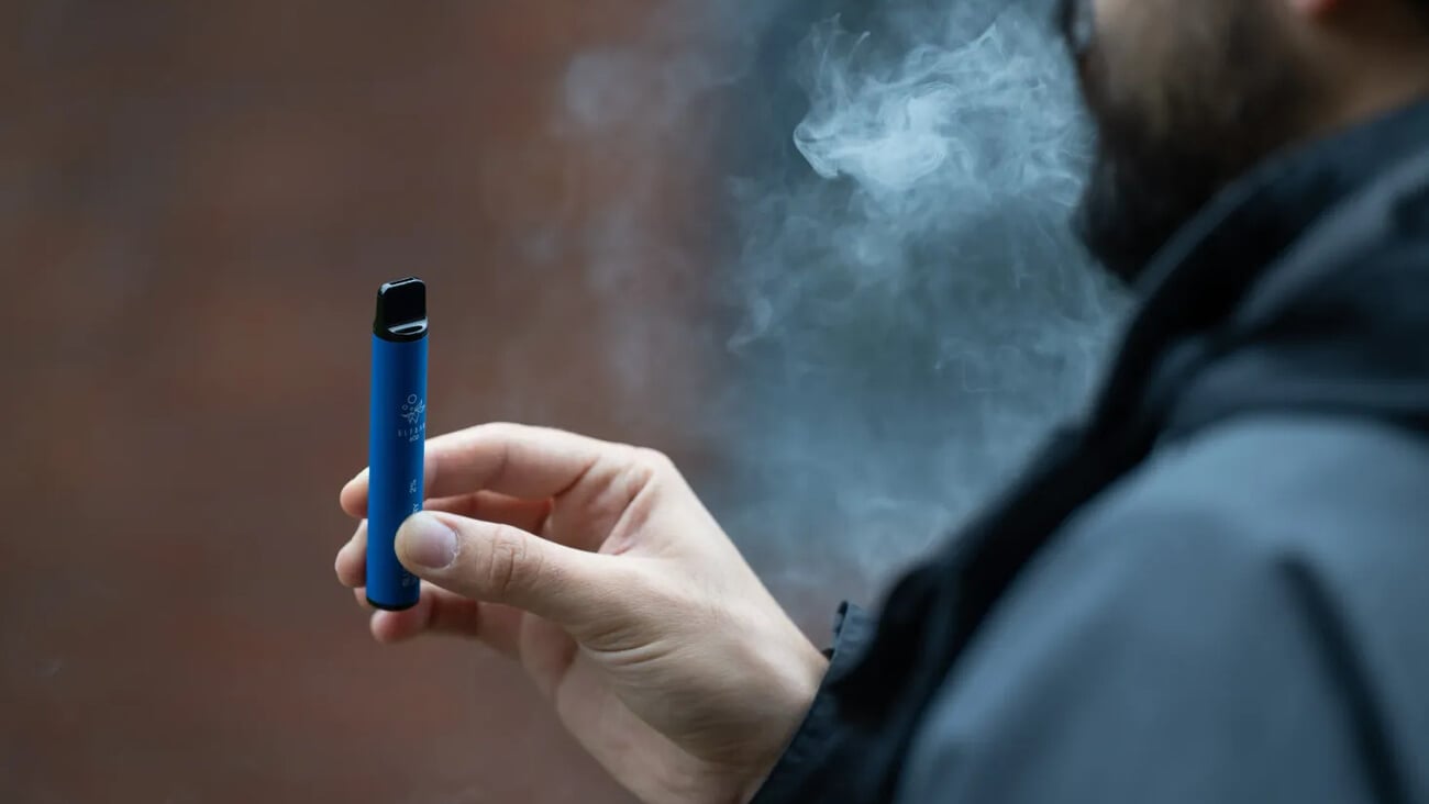 London, UK. 8 August 2023: A man vaping an e-cigarette in London.  Local councils are calling for the Government to ban the sale and manufacture of single-use vapes by 2024. ; Shutterstock ID 2344812279