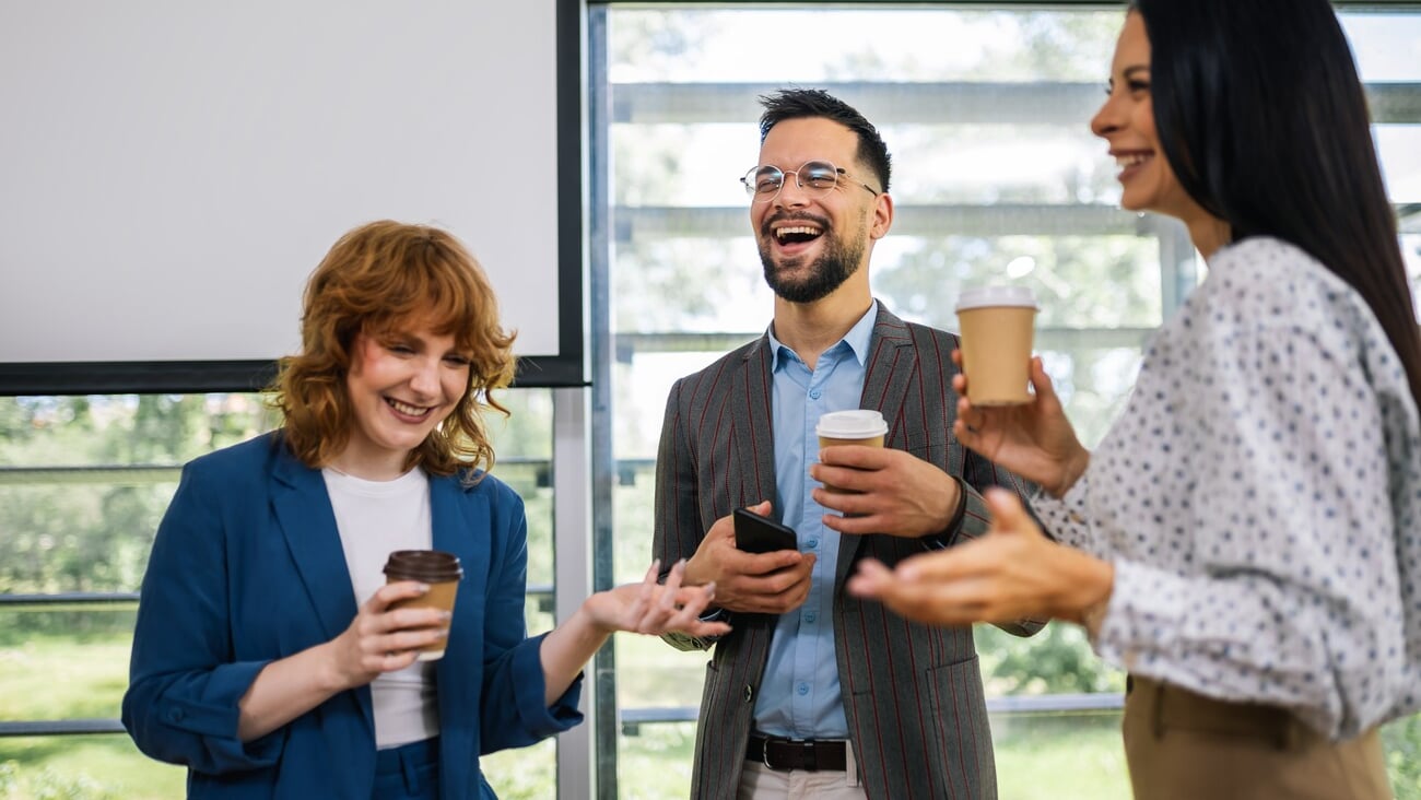 Group of multicultural colleagues standing in the conference room and having coffee break.; Shutterstock ID 2495852169
