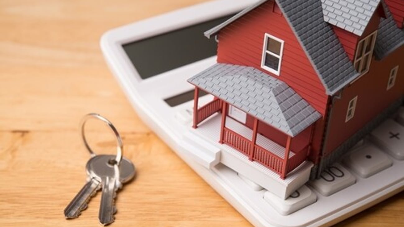 Red house model on white calculator and house key on wooden table background. Homebuyers, mortgage loan, banking, real estate investment trust (REIT), reverse mortgage, home selling or rental concept.; Shutterstock ID 2673029223