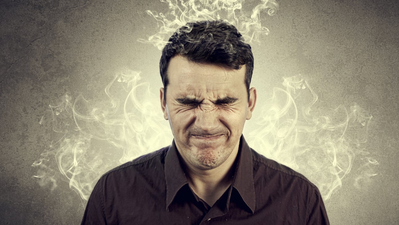 Portrait of Young man thinking too hard .Angry,Stressed man with waving smoke from head.; Shutterstock ID 272440361