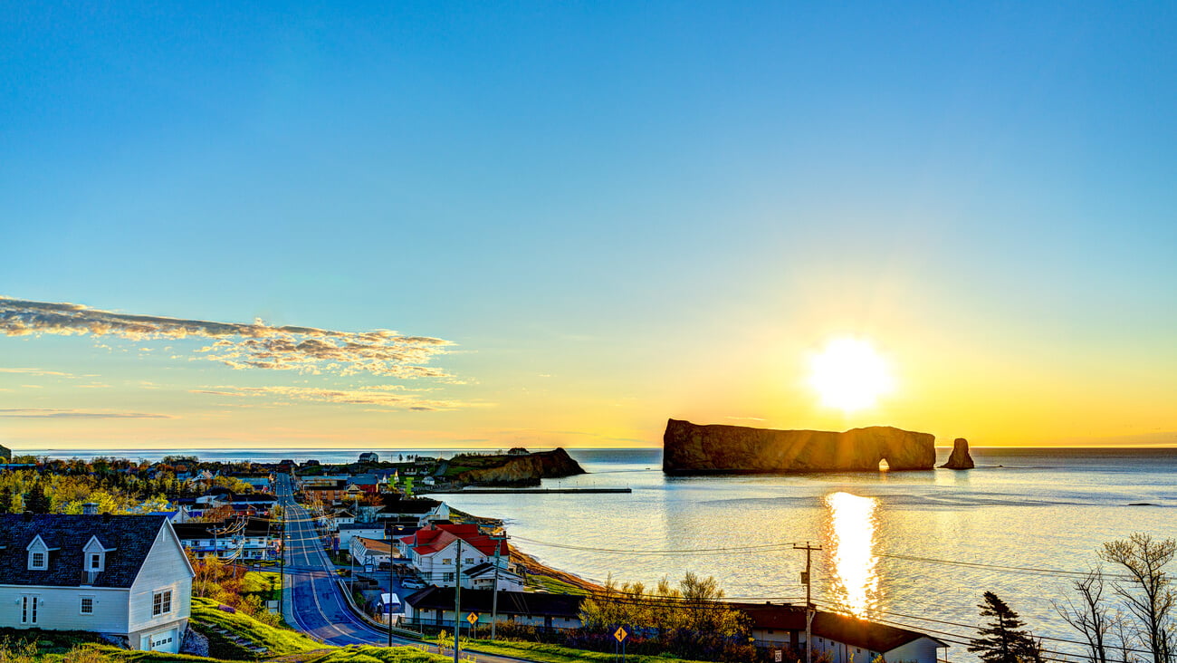 Famous Rocher Perce rock in Gaspe Peninsula, Quebec, Canada, Gaspesie region at blue sunrise and sun path; Shutterstock ID 694509094